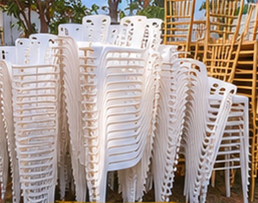 Stacked white and gold Chiavari chairs